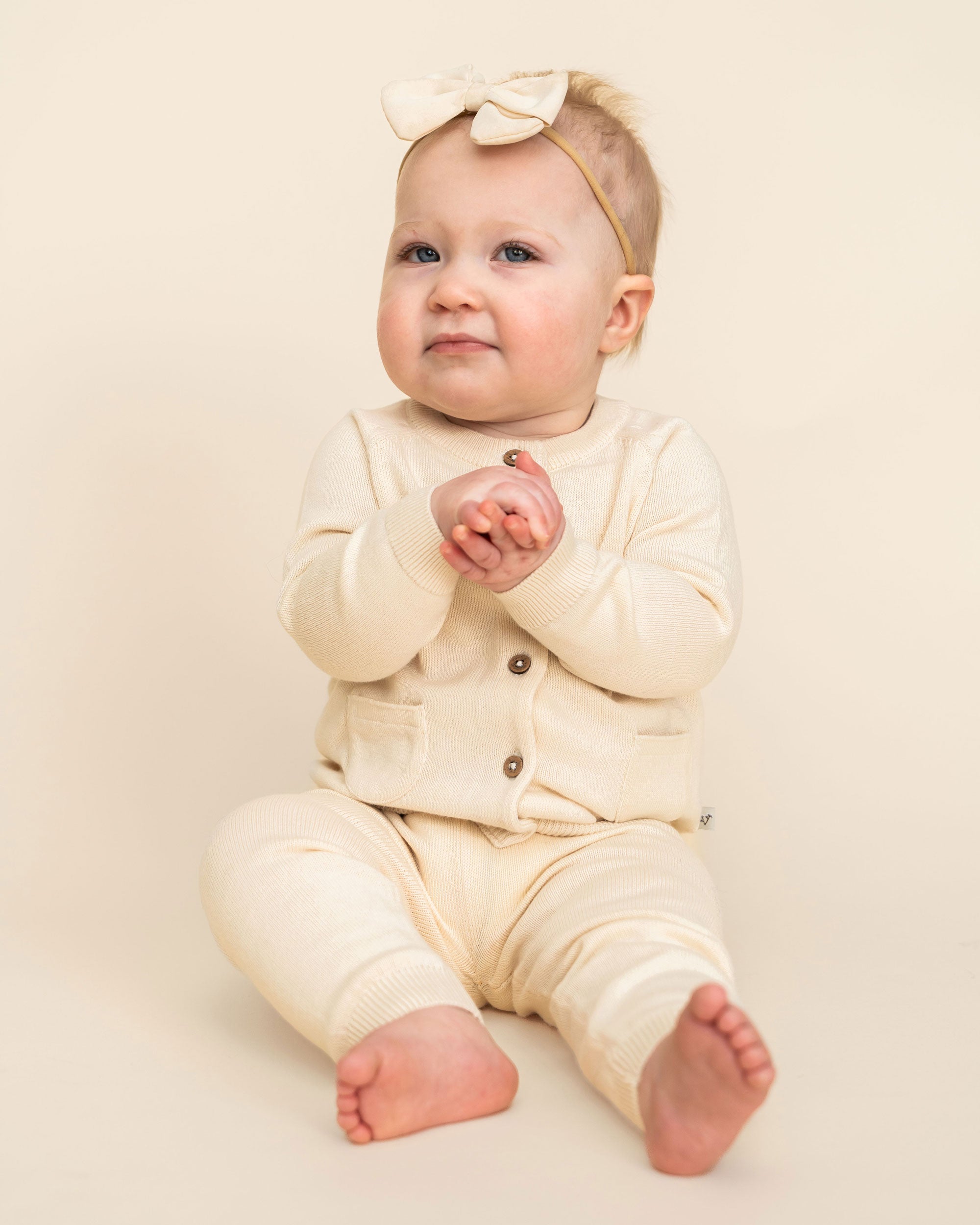 Cream Milan Knit Baby Button Cardigan Sweater (Organic Cotton) Model