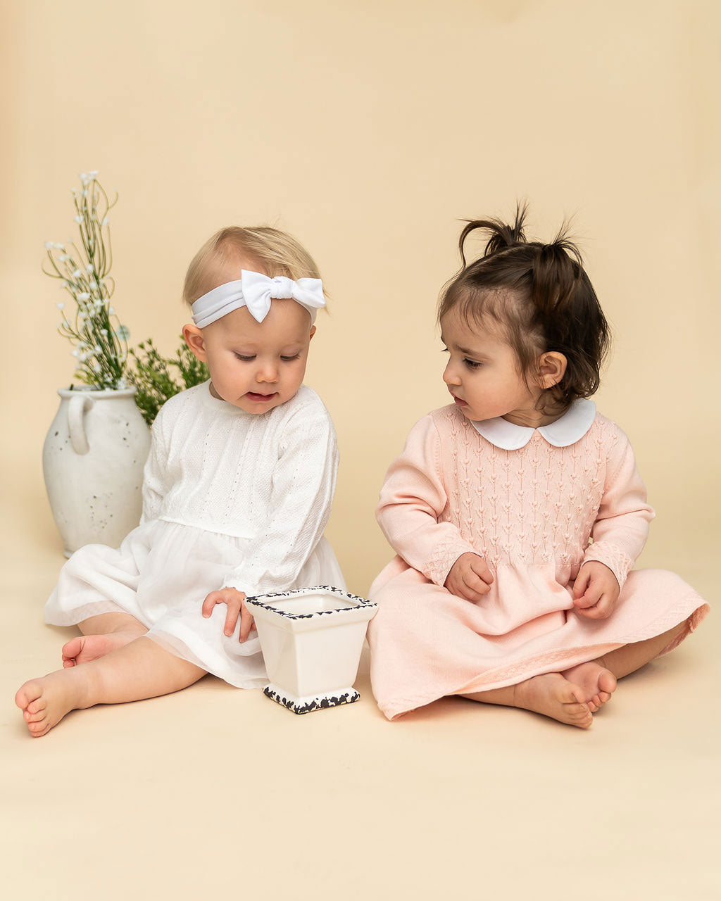 Models Wearing Milan Knit Baby Textured Tutu Dress (Left) & Blush Milan Knit Baby Peter Pan Tulip Sweater Dress (Right)