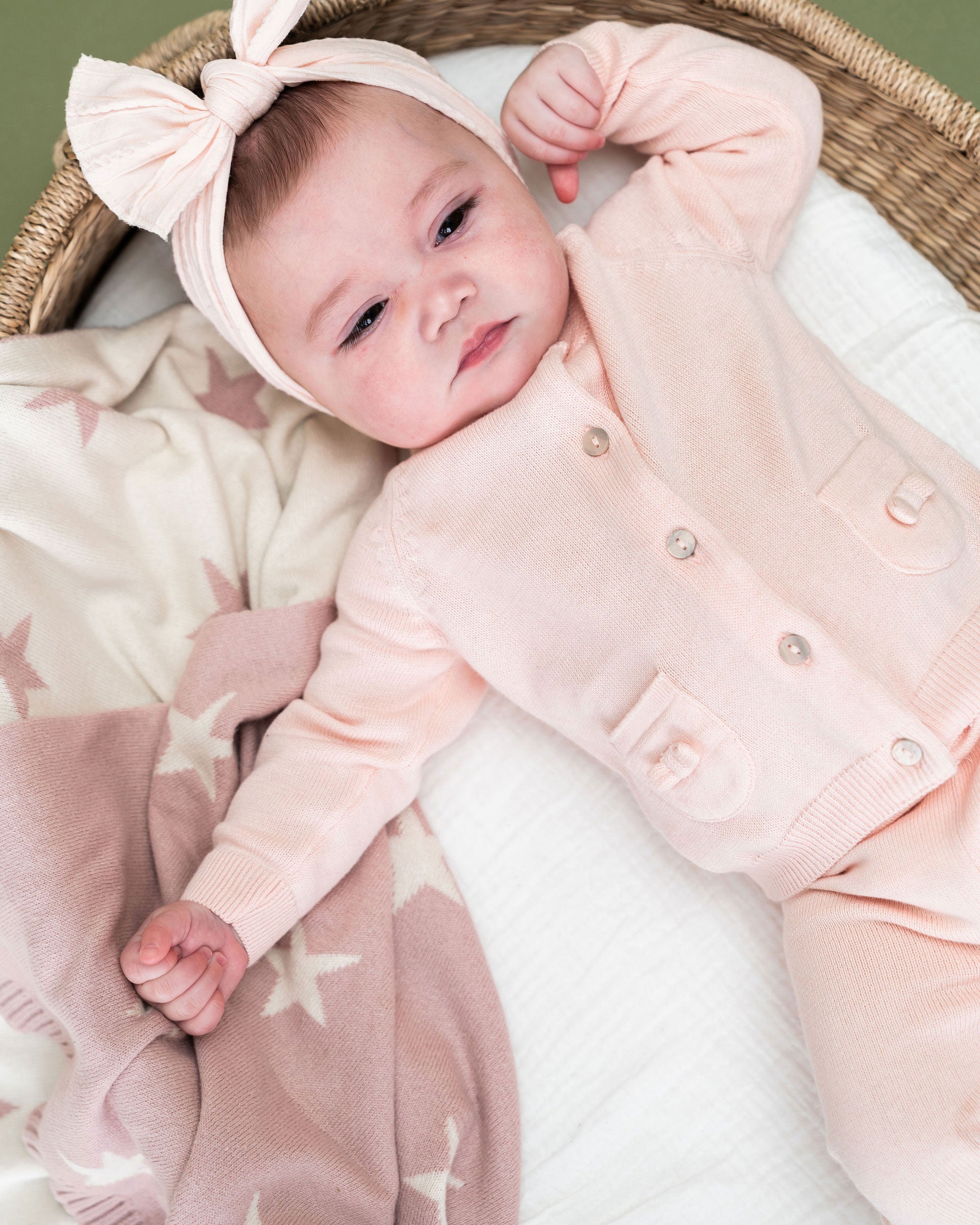 Blush Pink Stars - Reversible Sweater Knit Baby Blankets (Organic Cotton) with model wearing Viverano Milan outfit