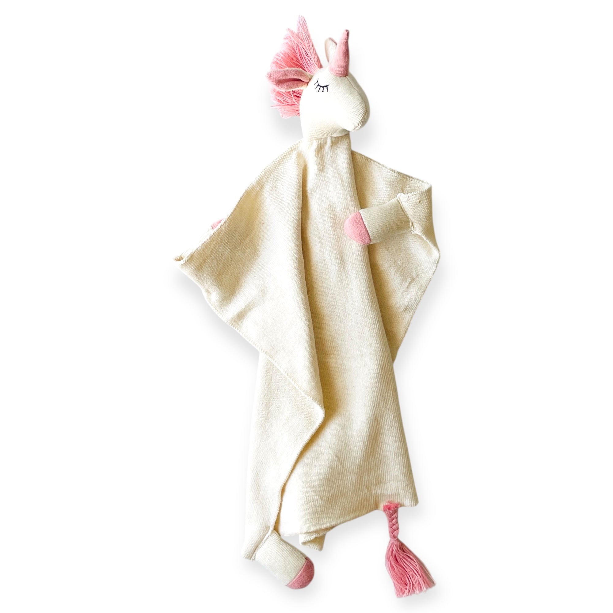 Unicorn-shaped comfort blanket with pink accents on a white background