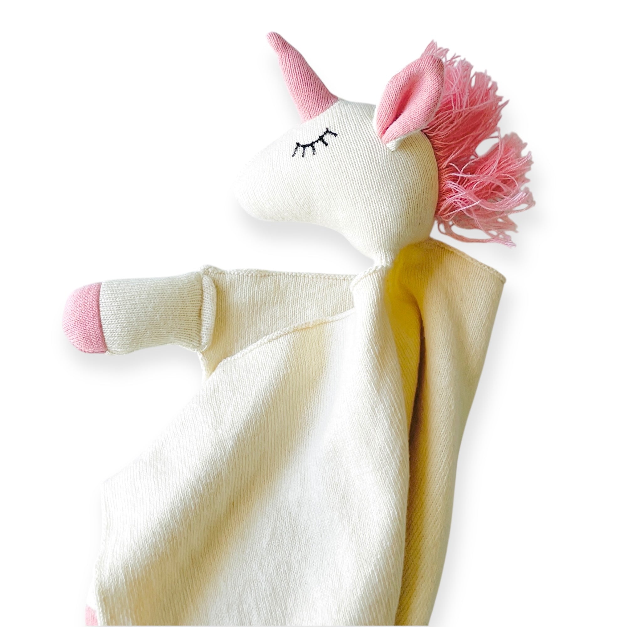 Unicorn-shaped plush toy with pink horn and mane on a white background