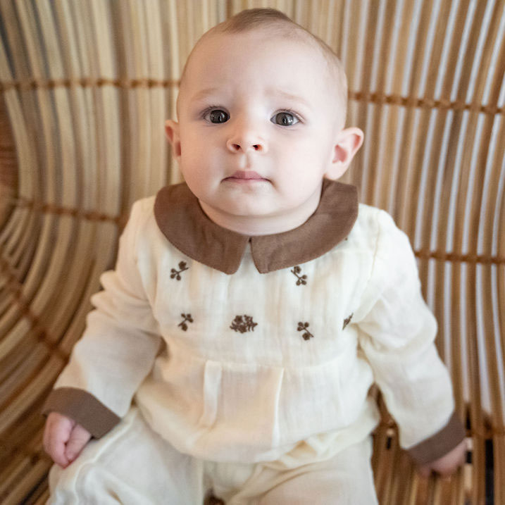 Baby wearing Organic Embroidered Crinkle Muslin Baby Jumpsuit