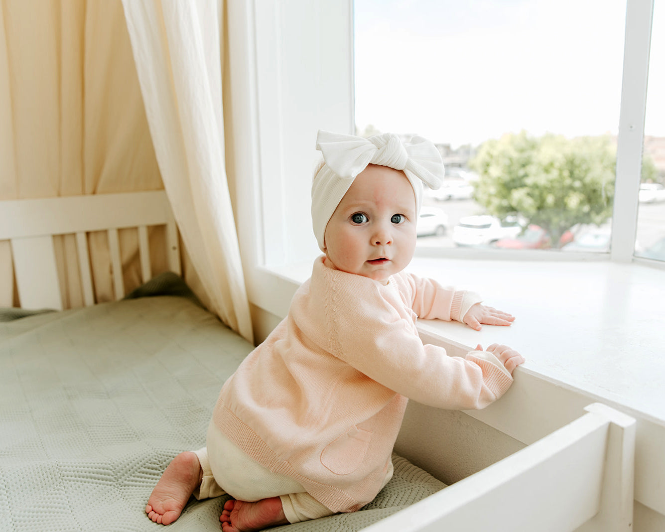 Blush Viverano Organic Cotton Knit Button Cardigan Sweater for Babies, Model