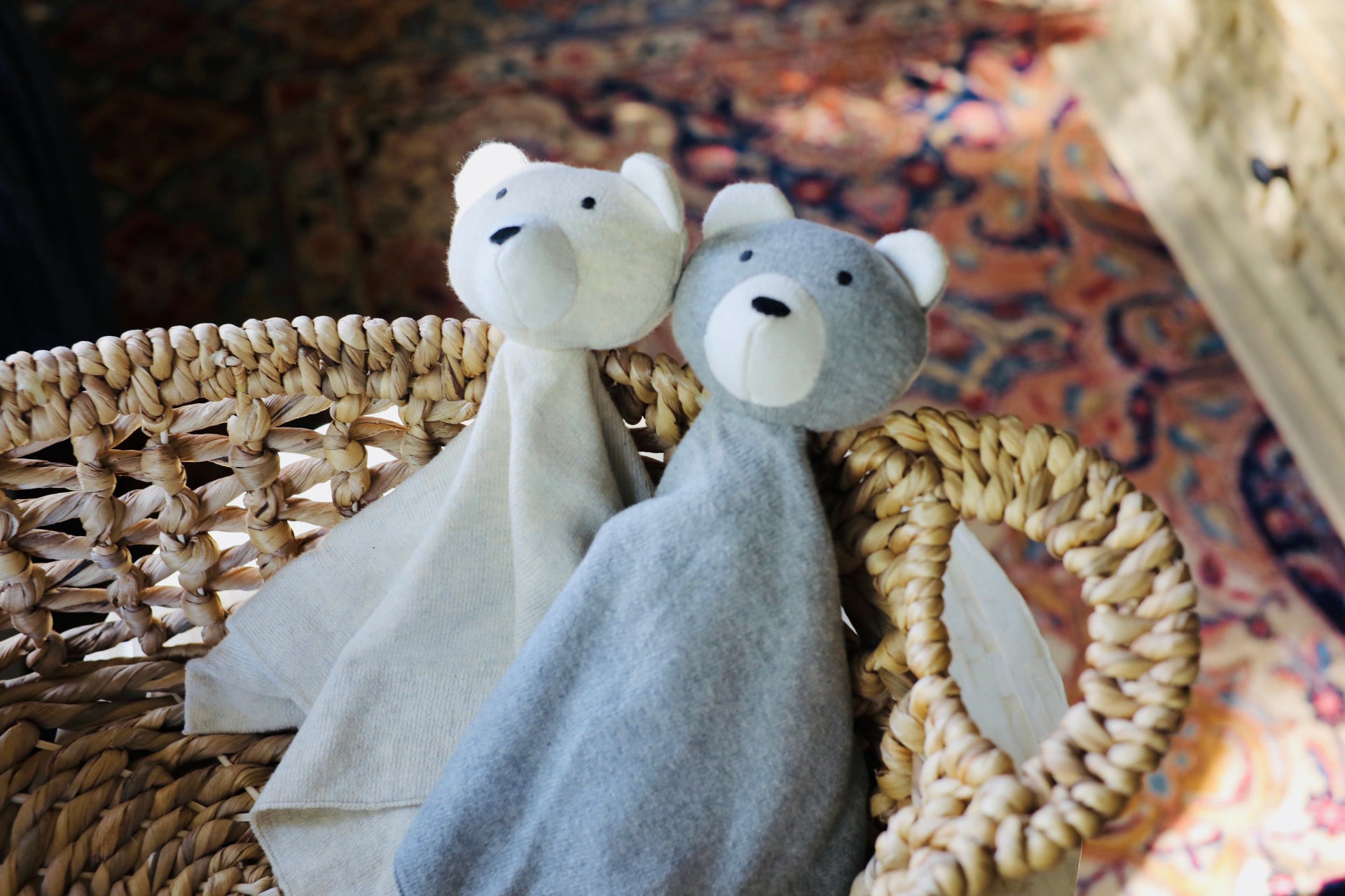 Viverano organic baby lovey blanket set with soft bear heads in beige and gray colors placed in woven basket