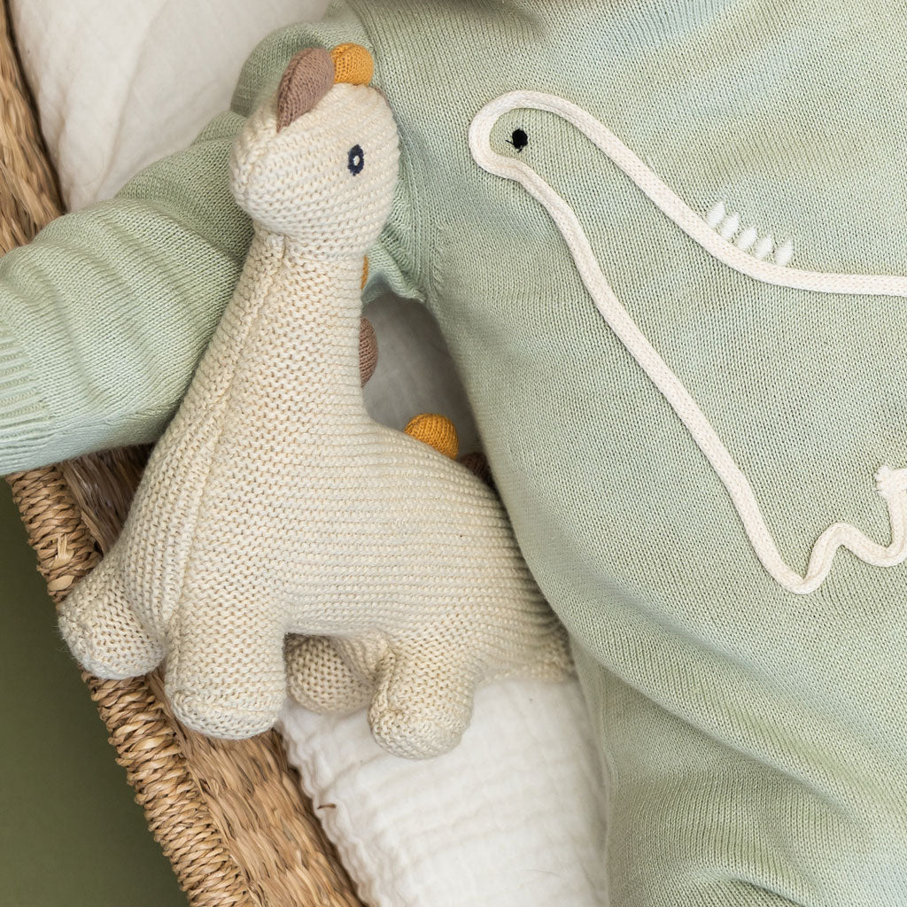 Little Dino - Organic Knit Stuffed Animal Baby Toy with model wearing Dino Jumpsuit