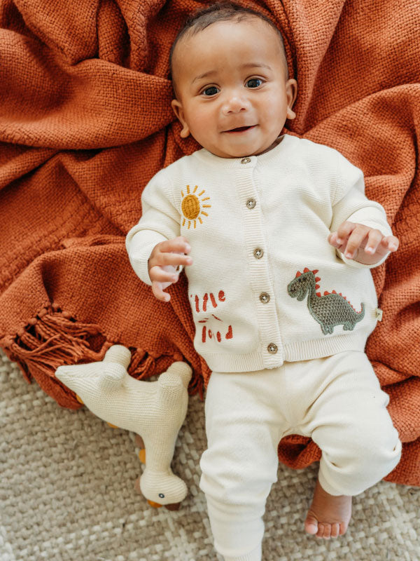 Little Dino - Organic Knit Stuffed Animal Baby Toy lifestyle with Little & Loved Cardigan
