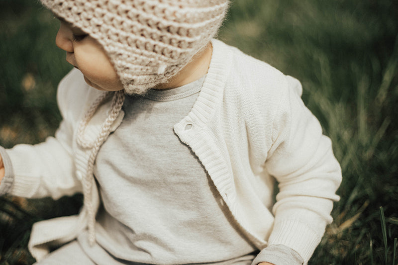 Dove White Viverano Organic Cotton Knit Button Cardigan Sweater for Babies Model Outside