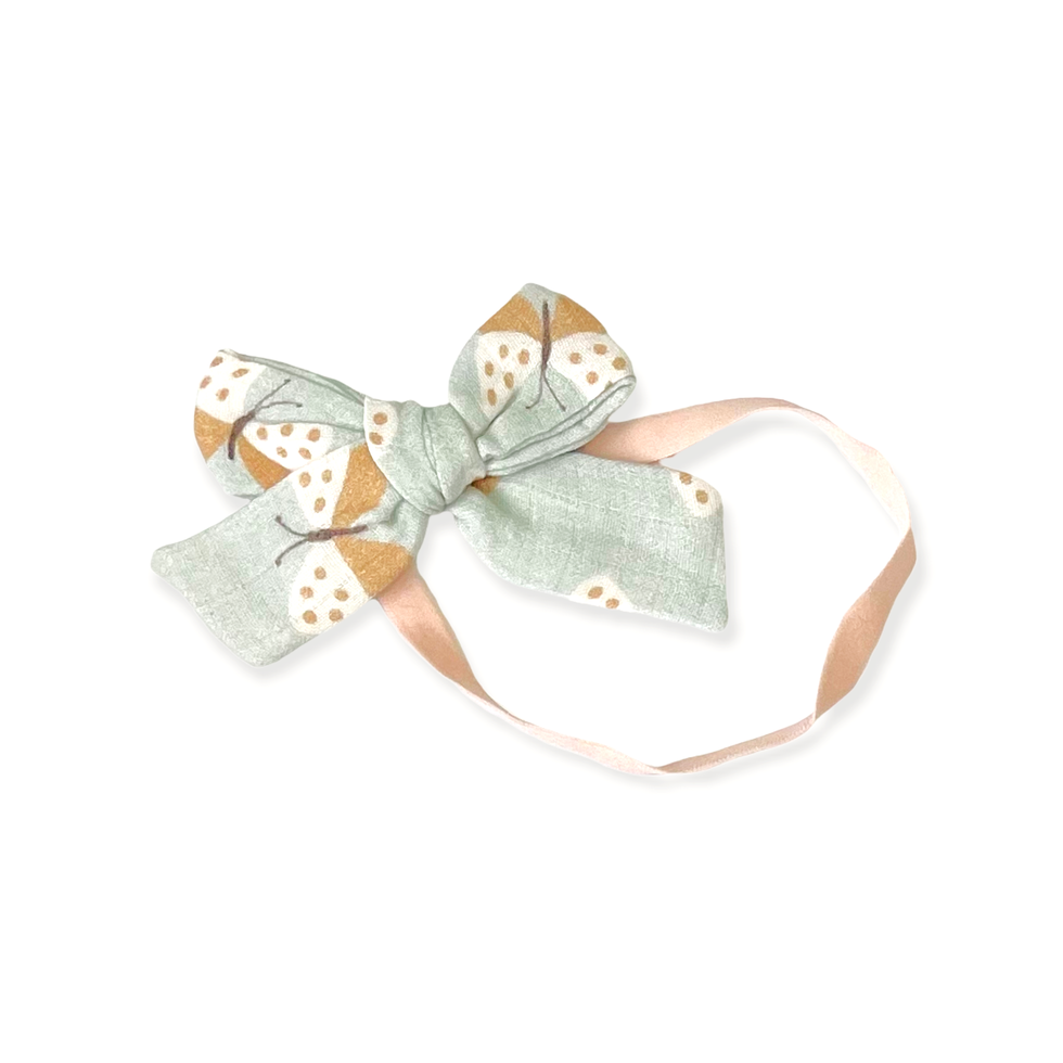 Diadema con lazo de mariposa (muselina orgánica)